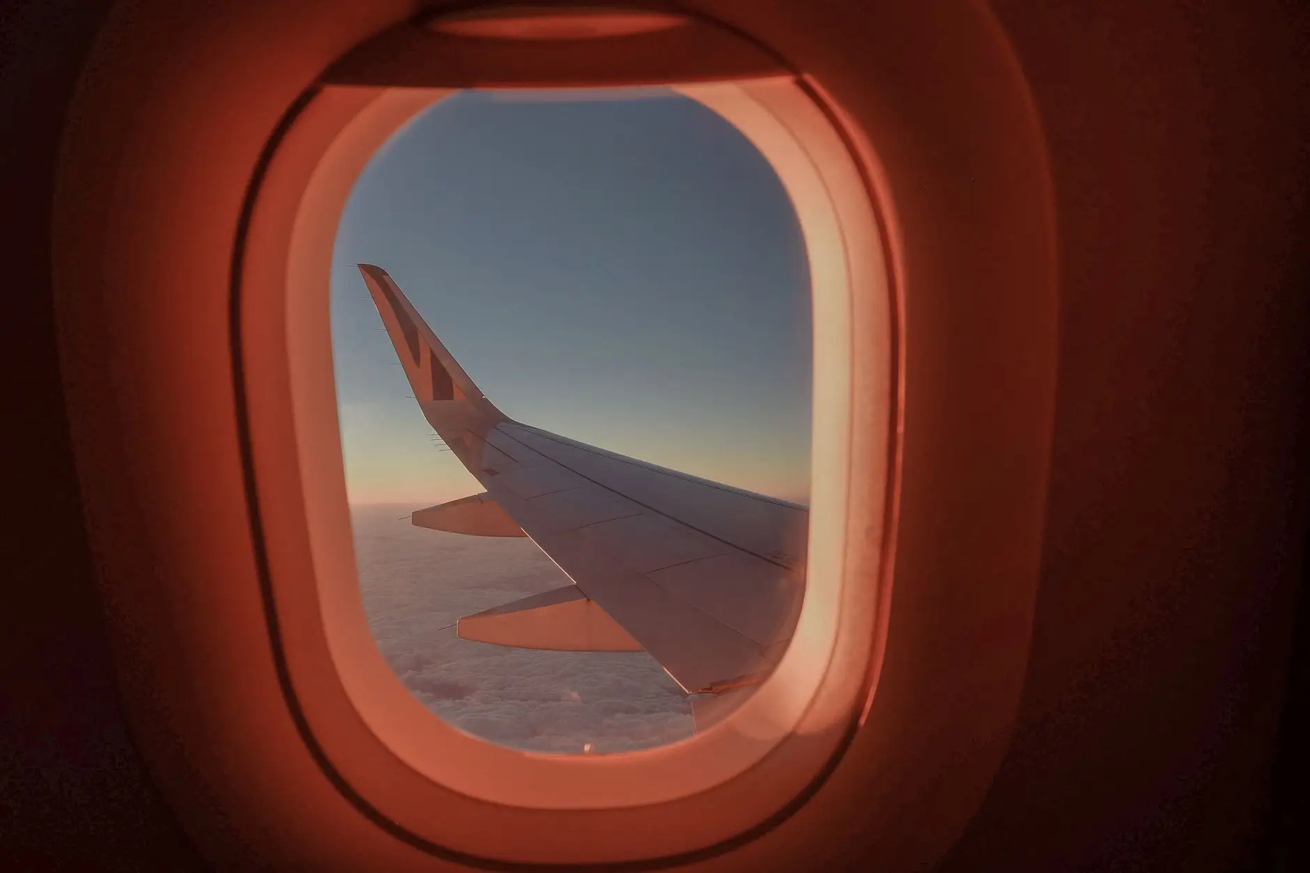 Get a free stopover in Portugal with TAP (and a 25% discount on an internal flight) - airplane wing view sunset flight